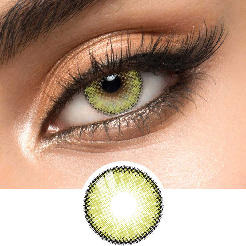 Close-up view of EyeCandys Desire Lush Green contact lens over a brown iris, demonstrating color transformation paired with natural eye makeup, next to a cutout of the contact lens