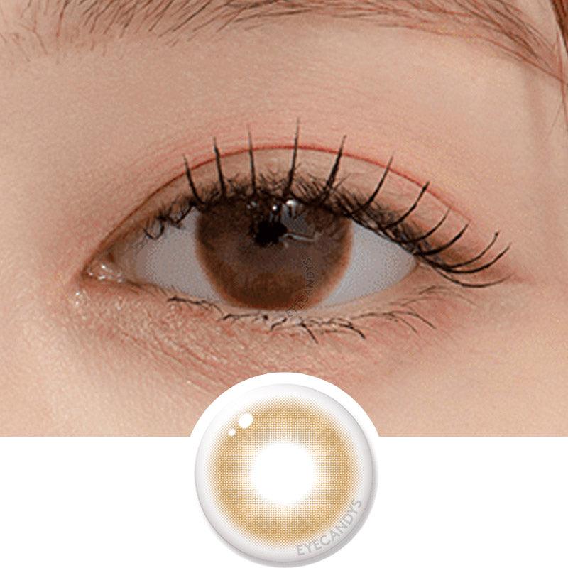 Macro shot of an eye wearing the DooNoon Touch Hazel prescription colour contact lens, showing the multi-colored detail and natural effect on dark brown eyes, with clean eye makeup. At the bottom is the pattern of the colored lens design, showing the dotted detail and pigmentation.